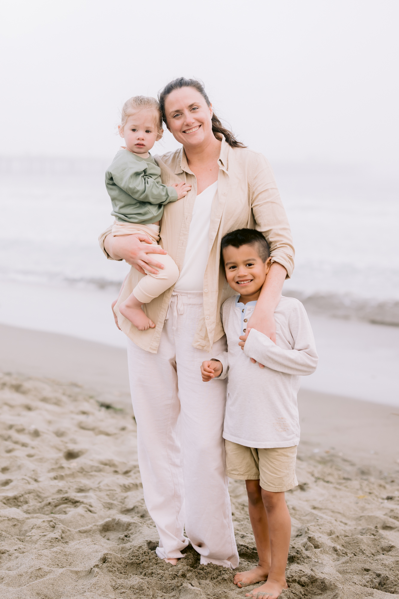 San Luis Obispo Nannies holding onto two young boys on the beach